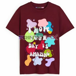A maroon t-shirt with colorful, playful blobs and text that reads I HOPE YOUR DAY IS AMAZING in bold white and pastel letters, featuring smiley face and flower designs, www.Printovix.com