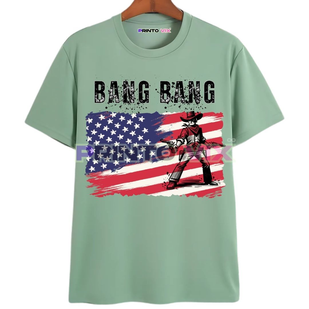17 - PrintoVix Mint green T-shirt featuring a distressed American flag background, bold BANG BANG text, and a cartoon cowboy holding pistols standing in front of the flag, www.Printovix.com