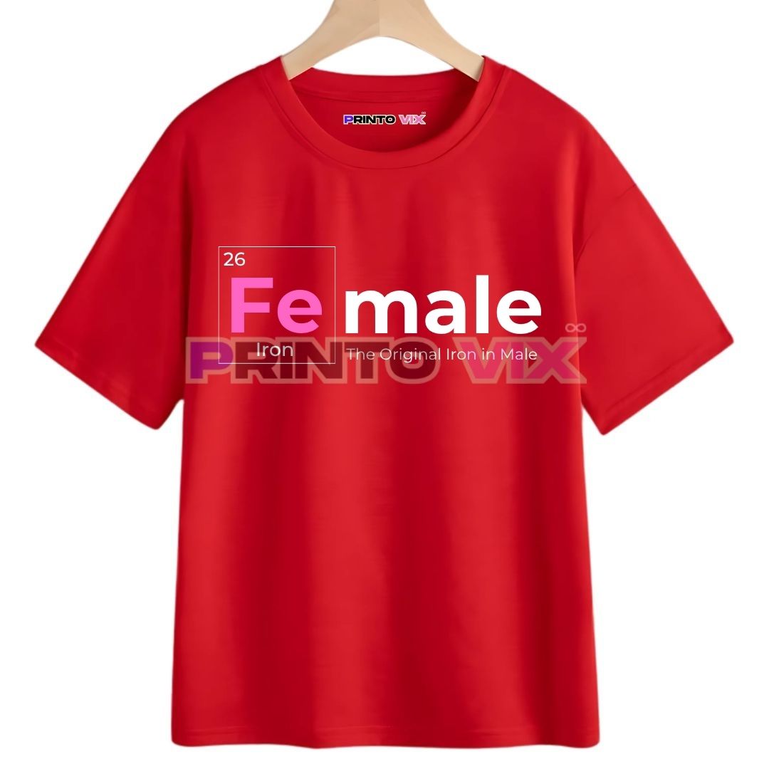 20 - PrintoVix A red T-shirt on a hanger features the word Female. The Fe is highlighted with 26 and Iron below, referencing irons symbol and atomic number on the periodic table. The original Iron in Male is also printed, www.Printovix.com